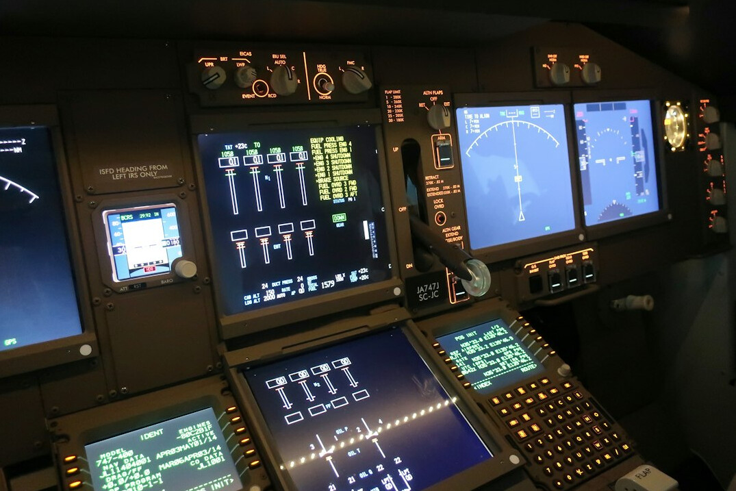 Broadcast control room with multiple monitors and mixing console